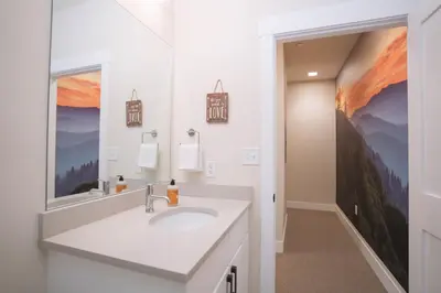 a bathroom with a sink and a mirror at WinterPark, Ski, CoffeeBar, Pets and CommunalHotTub in Winter Park