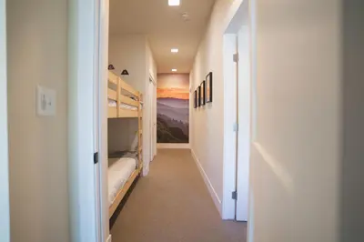 a hallway with two bunk beds in a room at WinterPark, Ski, CoffeeBar, Pets and CommunalHotTub in Winter Park