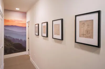 a hallway with four framed pictures on a wall at WinterPark, Ski, CoffeeBar, Pets and CommunalHotTub in Winter Park