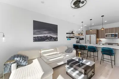 a living room with a couch and a kitchen at River West 635 in Silverthorne