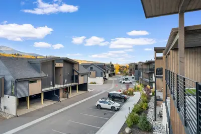 a street in a town with houses and a car at River West 635 in Silverthorne