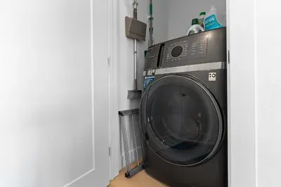 a washing machine in a room next to a door at River West 635 in Silverthorne