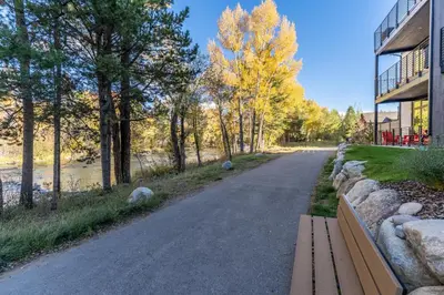 a road with a bench next to a building at River West 635 in Silverthorne