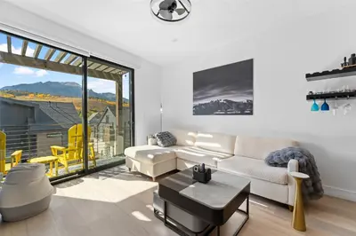 a living room with a couch and a large window at River West 635 in Silverthorne