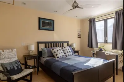 a bedroom with a bed and a chair at Energy-Efficient Oasis Cozy Near DT Boulder and trails in Boulder