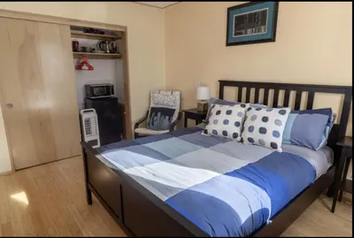 a bedroom with a large bed and a chair at Energy-Efficient Oasis Cozy Near DT Boulder and trails in Boulder