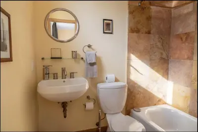 a bathroom with a toilet and a sink and a mirror at Energy-Efficient Oasis Cozy Near DT Boulder and trails in Boulder