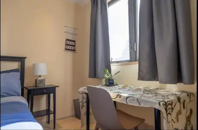 a bedroom with a table and a bed and a window at Energy-Efficient Oasis Cozy Near DT Boulder and trails in Boulder