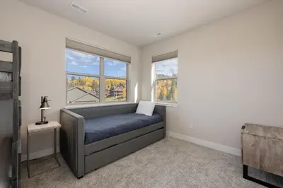 a bedroom with a bed and two windows at Wagon Wheel at Rendezvous home in Fraser