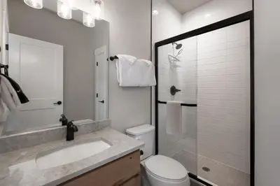 a white bathroom with a sink and a toilet at Wagon Wheel at Rendezvous home in Fraser