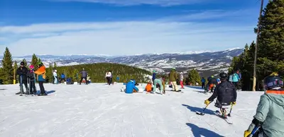 a group of people on a snow covered ski slope at Wagon Wheel at Rendezvous home in Fraser