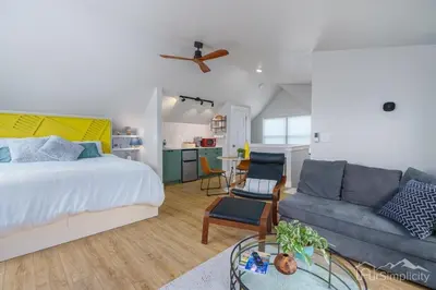 a bedroom and living room with a bed and a couch at Denver guesthouse w patio near Schafer Park in Denver
