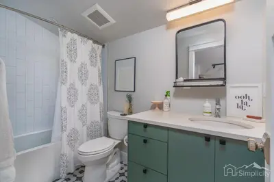 a bathroom with a toilet and a sink and a mirror at Denver guesthouse w patio near Schafer Park in Denver