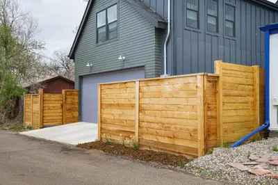 a wooden fence in front of a house at Denver guesthouse w patio near Schafer Park in Denver