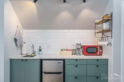 a kitchen with blue cabinets and a red microwave at Denver guesthouse w patio near Schafer Park in Denver