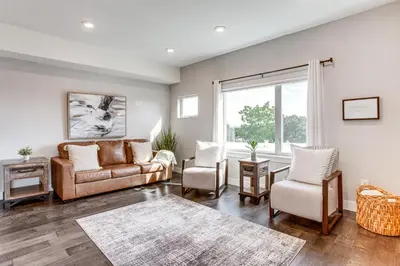 a living room with a couch and chairs and a window at 3 Mi to Dtwn Denver Scenic Townhome with Deck! in Denver