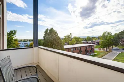 a balcony with a chair and a large window at 3 Mi to Dtwn Denver Scenic Townhome with Deck! in Denver