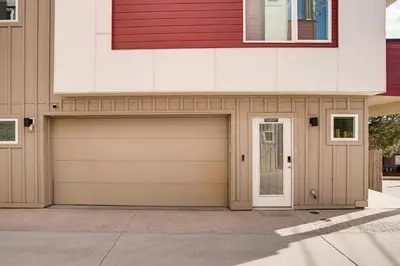 a house with a garage with a door at 3 Mi to Dtwn Denver Scenic Townhome with Deck! in Denver