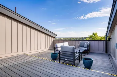 a balcony with two chairs on a building at 3 Mi to Dtwn Denver Scenic Townhome with Deck! in Denver