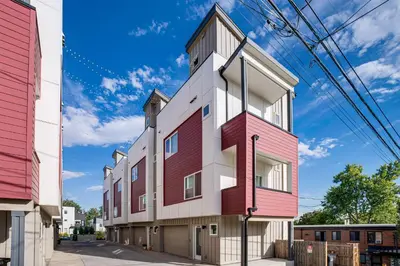 an apartment building with red and white at 3 Mi to Dtwn Denver Scenic Townhome with Deck! in Denver