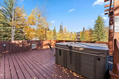 a wooden deck with a bench on top of it at Bright Keystone Getaway w Loft Near Ski Lifts in Keystone