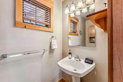 a white bathroom with a sink and a mirror at Bright Keystone Getaway w Loft Near Ski Lifts in Keystone