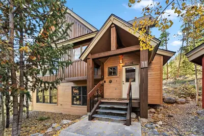 a tiny house with stairs leading to the front door at Bright Keystone Getaway w Loft Near Ski Lifts in Keystone