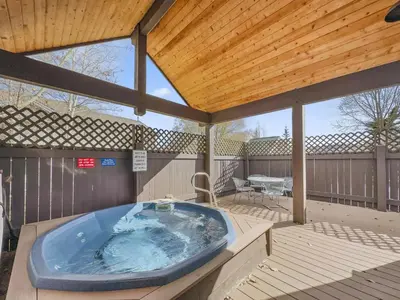 a large hot tub on a deck with a wooden ceiling at B6 Tarn Landing 1Br Loft, 3Ba condo in Frisco