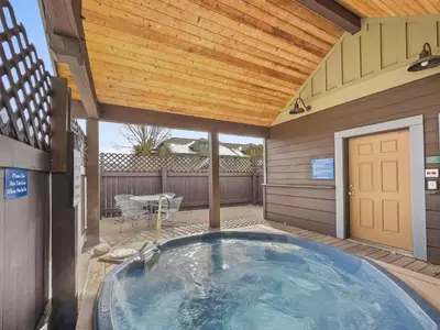a hot tub in a backyard with a wooden ceiling at B6 Tarn Landing 1Br Loft, 3Ba condo in Frisco