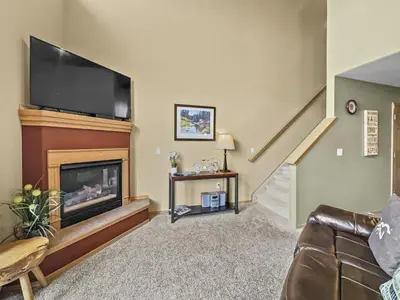 a living room with a fireplace and a flat screen tv at B6 Tarn Landing 1Br Loft, 3Ba condo in Frisco