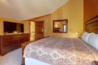 a bedroom with a large bed and a television at A2 Marina Park 3Br 3,5Ba condo in Frisco