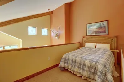 a bedroom with a bed in a room with orange walls at A2 Marina Park 3Br 3,5Ba condo in Frisco