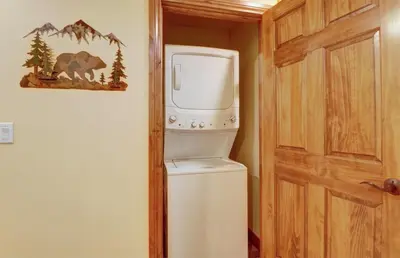 a refrigerator with a water dispenser next to a door at A2 Marina Park 3Br 3,5Ba condo in Frisco