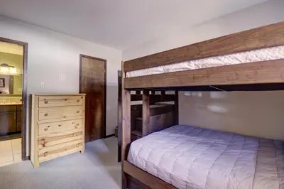 a bedroom with two bunk beds and a dresser at E101 Lake Cliffe condo in Dillon