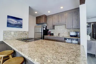 a kitchen with wooden cabinets and a granite counter top at E101 Lake Cliffe condo in Dillon