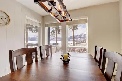 a dining room with a table and a clock at E101 Lake Cliffe condo in Dillon