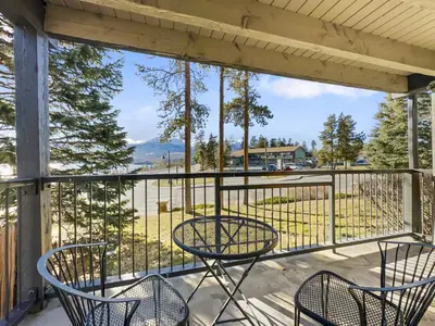 a balcony with chairs and a view of a park at E101 Lake Cliffe condo in Dillon