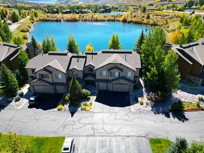 an aerial view of a house with a lake at 152 Ponds on the Blue River home in Silverthorne