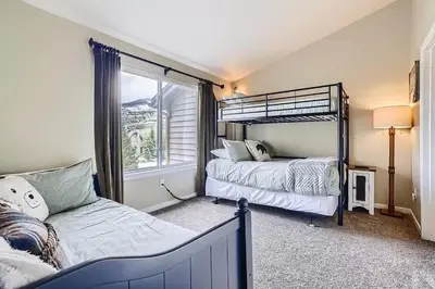 a bedroom with two bunk beds and a window at 152 Ponds on the Blue River home in Silverthorne