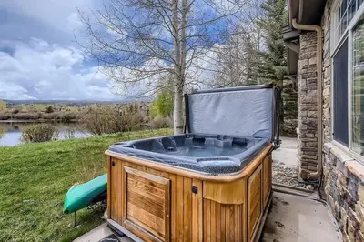 a hot tub sitting on the side of a house at 152 Ponds on the Blue River home in Silverthorne