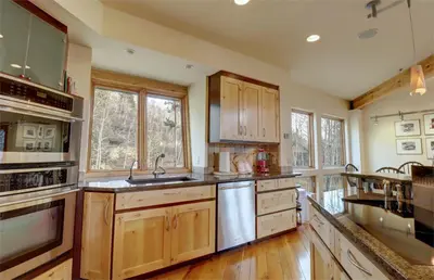 a kitchen with wooden cabinets and stainless steel appliances at 11 Stormwatch Circle 4Br 3,5Ba home in Silverthorne