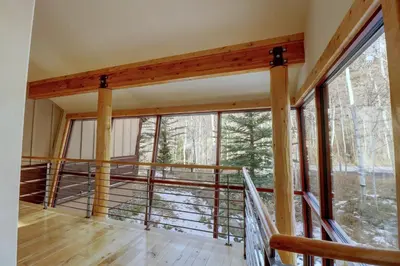 a room with a balcony with large windows at 11 Stormwatch Circle 4Br 3,5Ba home in Silverthorne