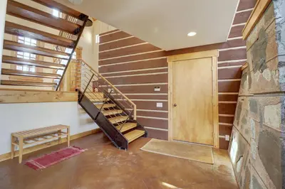 a staircase in a house with a wooden wall at 11 Stormwatch Circle 4Br 3,5Ba home in Silverthorne