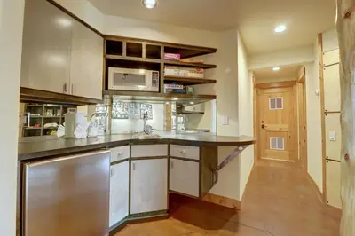 a kitchen with a sink and a microwave at 11 Stormwatch Circle 4Br 3,5Ba home in Silverthorne