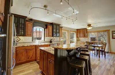 a kitchen with wooden cabinets and a large island at 334 Willow Lake Ct, 4Br withloft 3Ba townhouse in Silverthorne