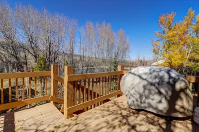 a wooden deck with a wooden fence and trees at 334 Willow Lake Ct, 4Br withloft 3Ba townhouse in Silverthorne