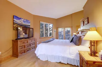 a bedroom with a large bed and a television at 334 Willow Lake Ct, 4Br withloft 3Ba townhouse in Silverthorne