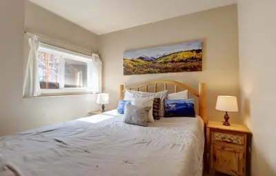 a bedroom with a bed and a painting on the wall at 334 Willow Lake Ct, 4Br withloft 3Ba townhouse in Silverthorne