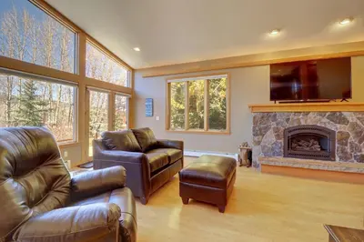 a living room with leather furniture and a fireplace at 334 Willow Lake Ct, 4Br withloft 3Ba townhouse in Silverthorne