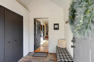 a hallway of a home with a black door and a porch sidx at Silver Lining Circle home in Fraser